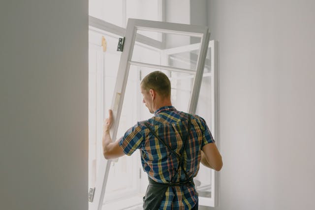 Maintenance worker fixing a window